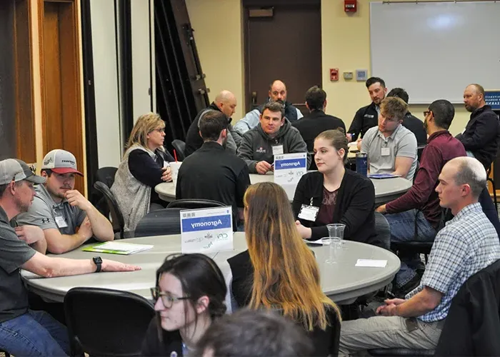 students sit and discuss at a roundtable event